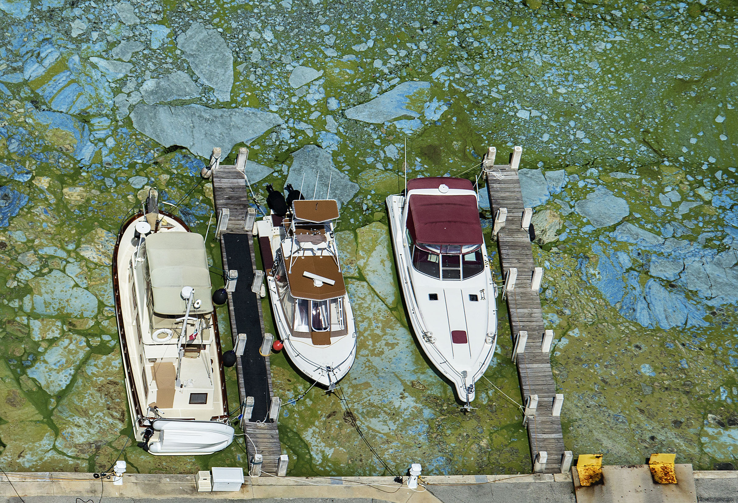 PHOTO: Boats docked at Central Marine in Stuart, Fla., are surrounded by blue green algae, June 29, 2016. Officials want federal action along the stretch of Florida's Atlantic coast where the governor has declared a state of emergency over algae blooms. 