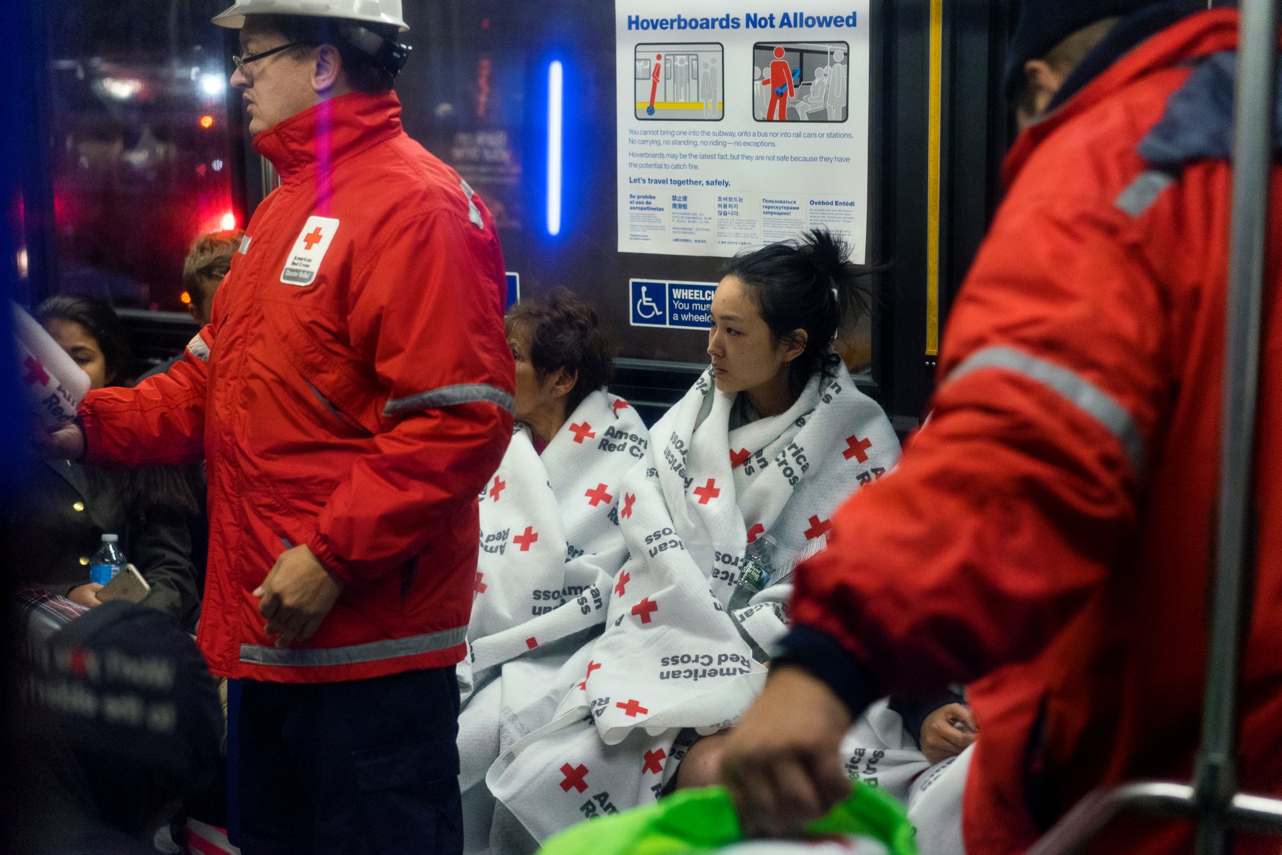 PHOTO: Members of the Red Cross assist people gathering on a city bus, Oct. 27, 2016, after fleeing the area from a fire at an apartment building on the Upper East Side in New York. 