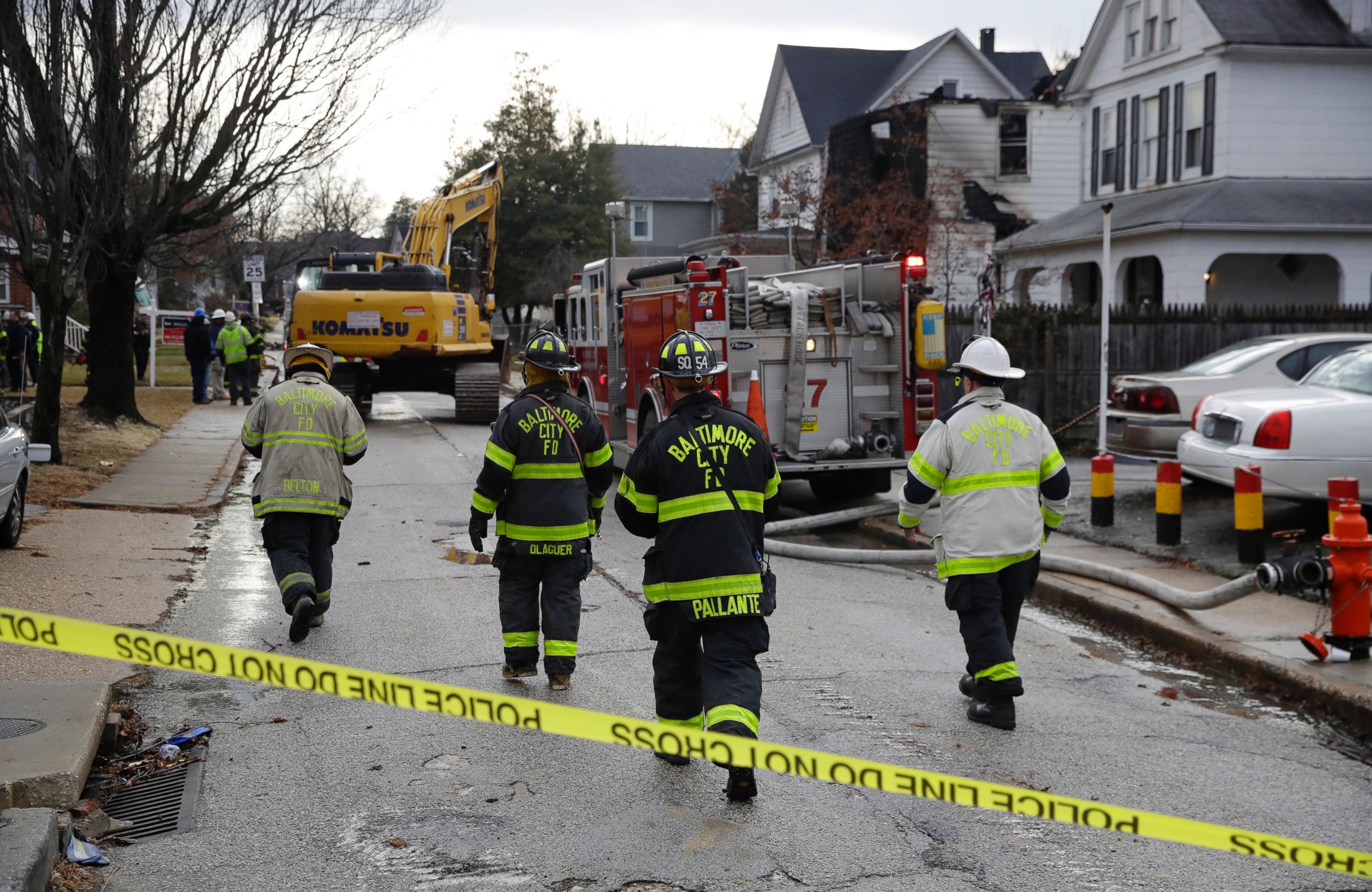 PHOTO: Fire officials approach the scene of an early morning house fire in Baltimore, Jan. 12, 2017. 