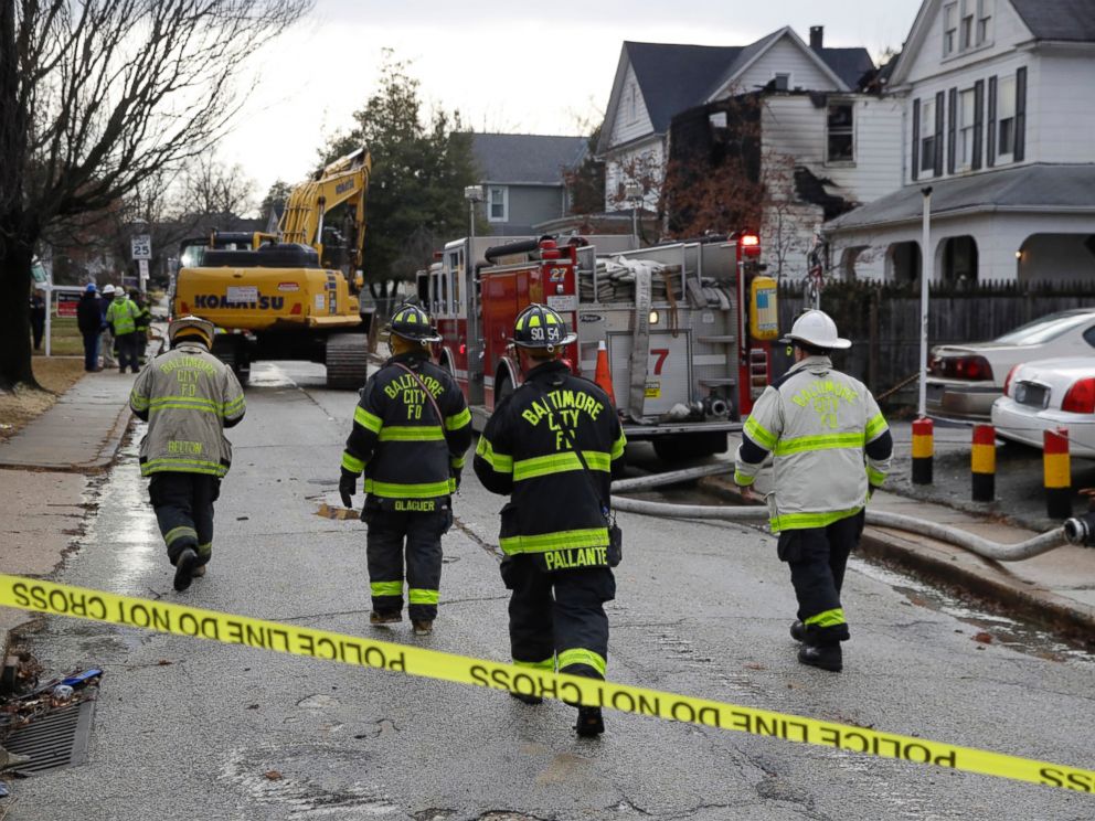 PHOTO: Fire officials approach the scene of an early morning house fire in Baltimore, Jan. 12, 2017.
