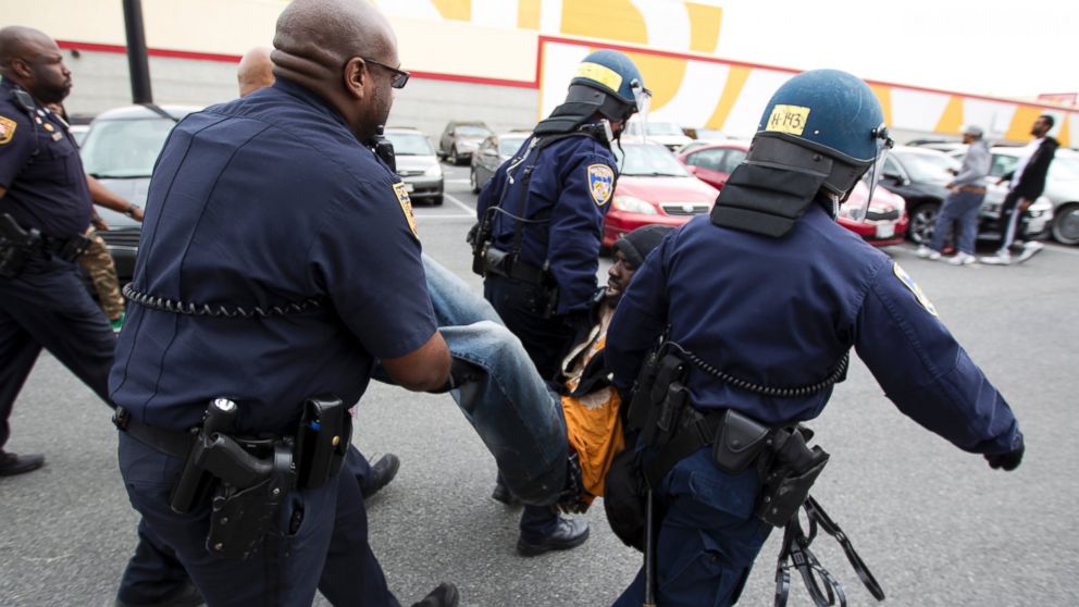 Baltimore police officers detain a demonstrator on April 27, 2015 in Baltimore, Md.