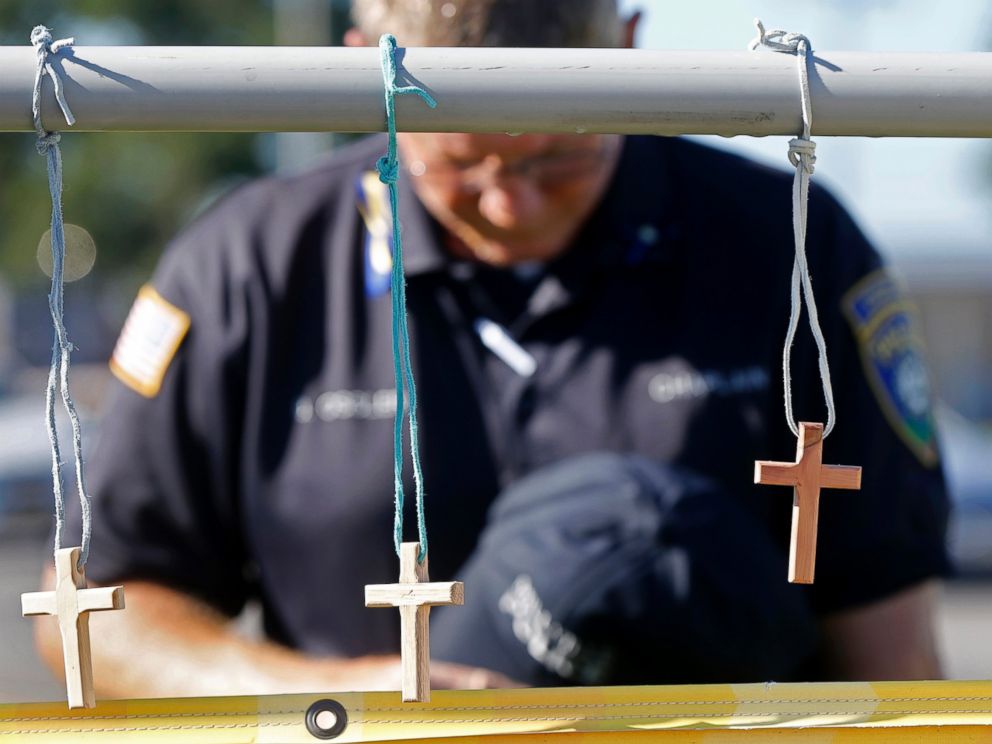 PHOTO: Millville, N.J. police chaplain Robert Ossler prays, July 18, 2016, at a makeshift memorial at the fatal shooting scene in Baton Rouge, La., where several law enforcement officers were killed.
