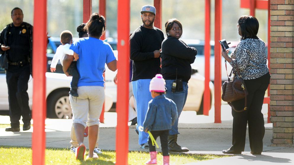 Parents arrive at Marshall Middle School in Beaumont, Texas, Jan. 28, 2016, after an evacuation from an alleged carbon monoxide leak. Sick students were transported to local hospitals while unaffected students were taken to West Brook High School.