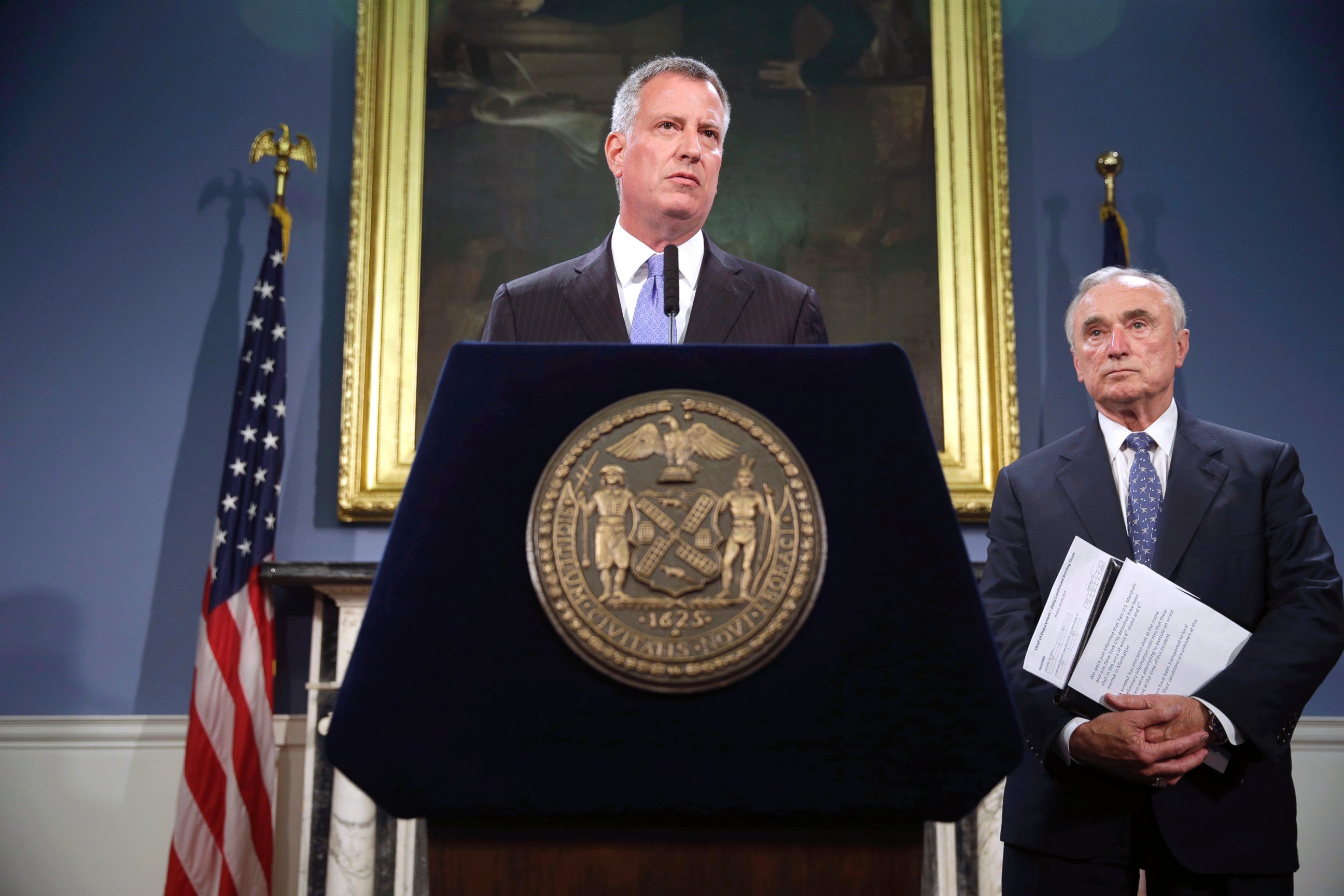 PHOTO: New York City mayor Bill de Blasio, center, and police commissioner Bill Bratton speak to reporters during a news conference in New York in this July 28, 2014 file photo.