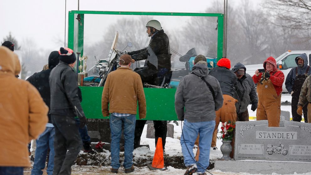 PHOTO: The body of Bill Standley, secured to his 1967 Harley Davidson, rests inside a plexiglass box before being lowered into the ground at the cemetery in Mutual, Ohio on Friday, Jan. 31, 2014.