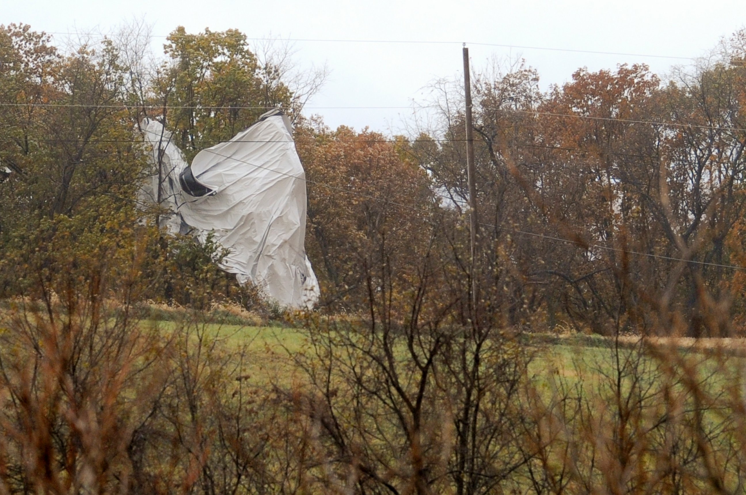 PHOTO: Part of an Army surveillance blimp hangs off a group of trees on Oct. 28, 2015 after crash landing near Muncy, Pa. 
