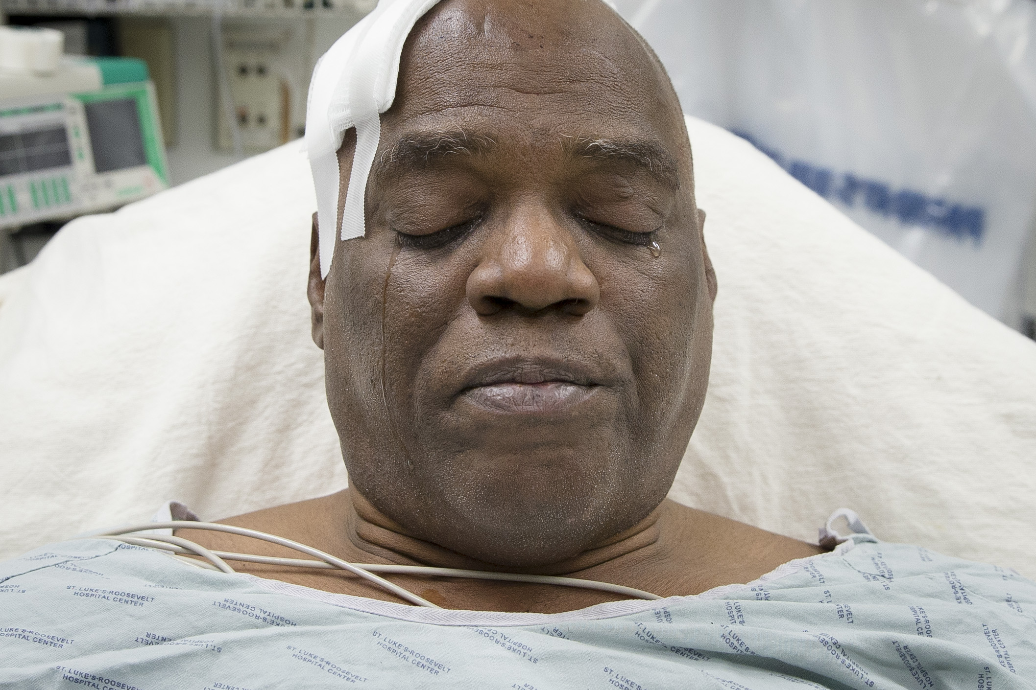 PHOTO: Cecil Williams cries during an interview as he rests in his hospital bed following a fall onto subway tracks from the platform at 145th Street, Dec. 17, 2013, in New York.