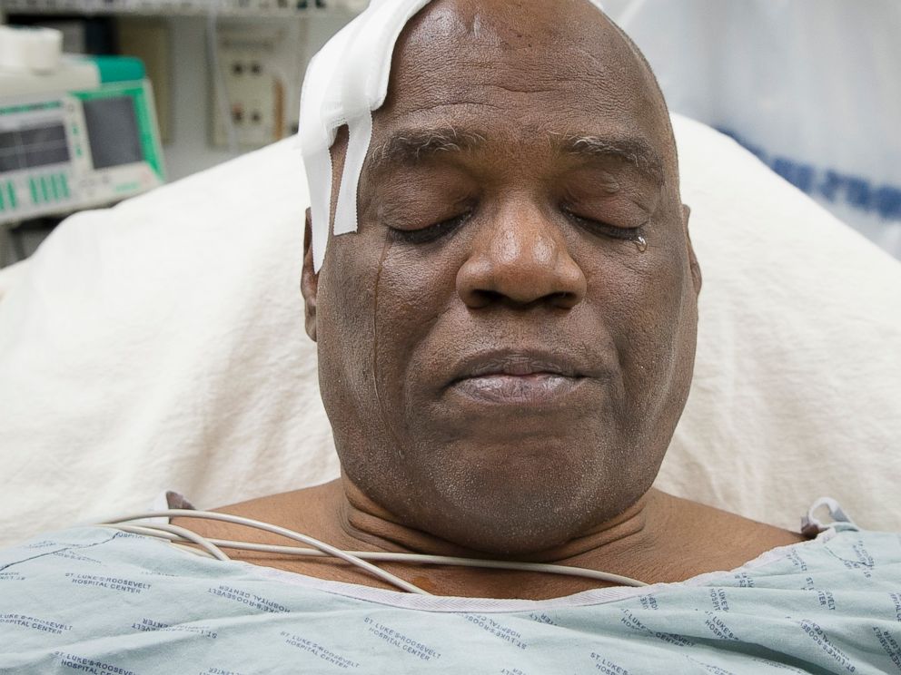 PHOTO: Cecil Williams cries during an interview as he rests in his hospital bed following a fall onto subway tracks from the platform at 145th Street, Dec. 17, 2013, in New York.