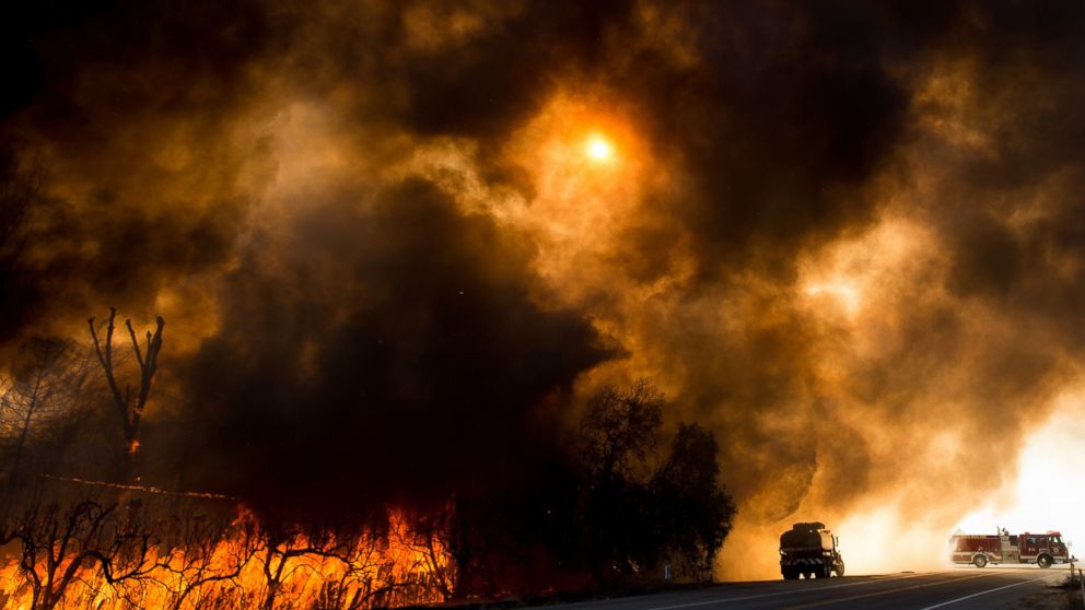 Firefighters battle a wildfire as it crosses Cajon Boulevard in Keenbrook, California, Aug. 17, 2016.