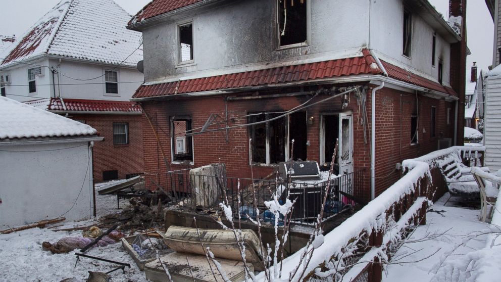 Debris lay scattered behind the house at the scene of a fire in the Brooklyn borough of New York, March 21, 2015. 