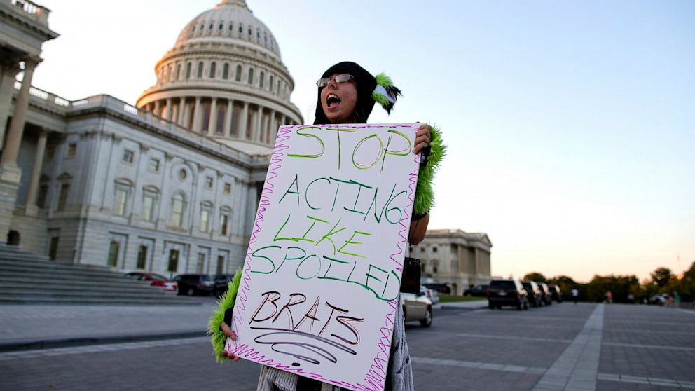 Janette Dunder of Alexandria, Va., protests outside the Capitol building as Congress continues the budget battle, Sept. 30, 2013, in Washington.