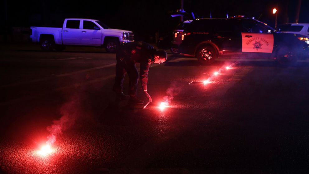 PHOTO: A police officer lights up flares near the scene where a shootout took place, Dec. 2, 2015, in San Bernardino, Calif.