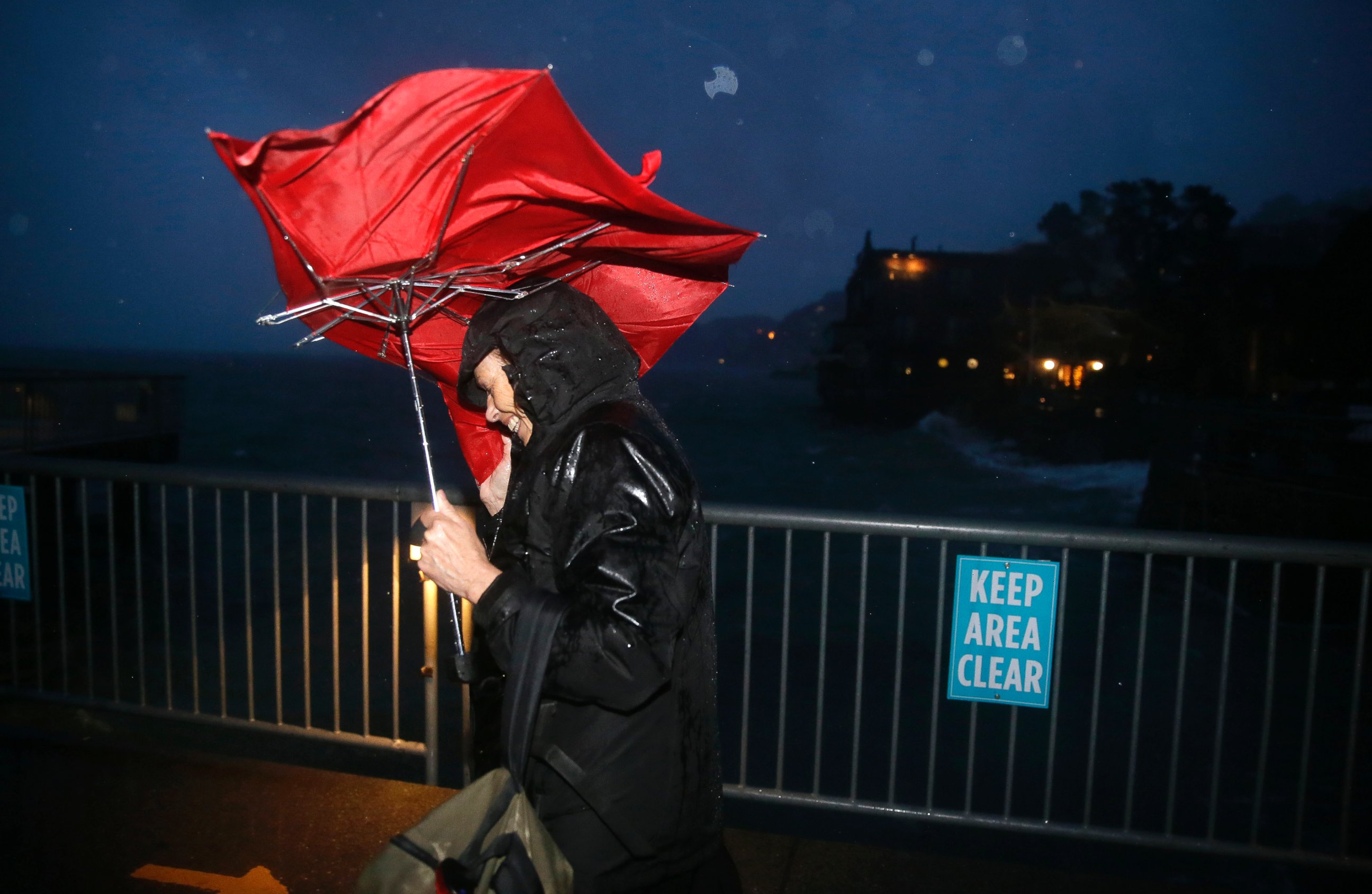 PHOTO: Commuter ML Mann struggles in the wind and rain to make her way to catch a ferry, Dec. 11, 2014, to San Francisco from Sausalito, Calif.