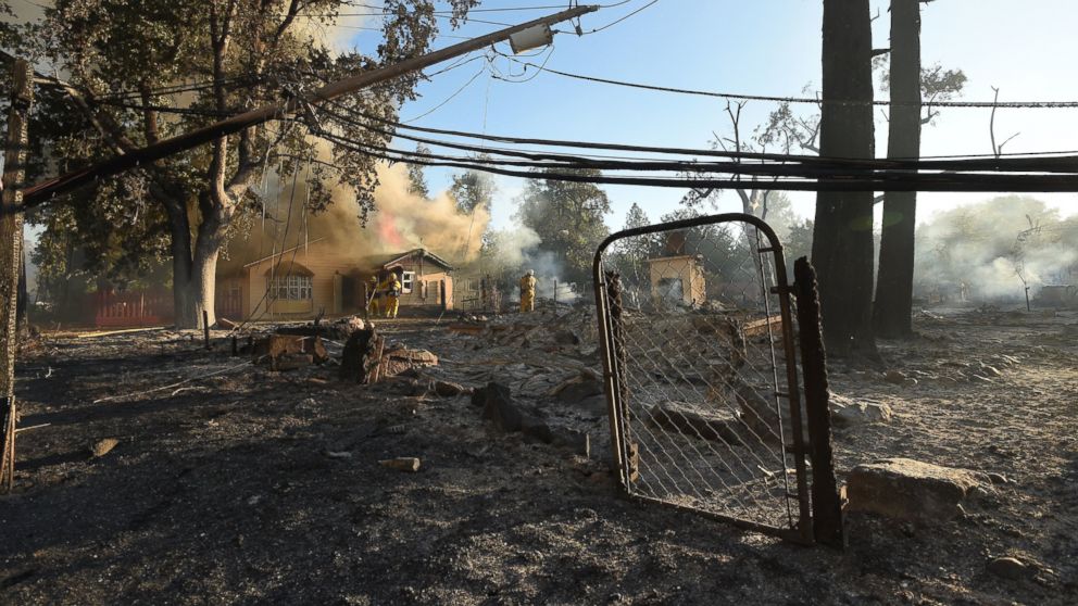 PHOTO: Firefighters work to control flames as a home burns in the town of Lower Lake, California, Aug. 14, 2016.