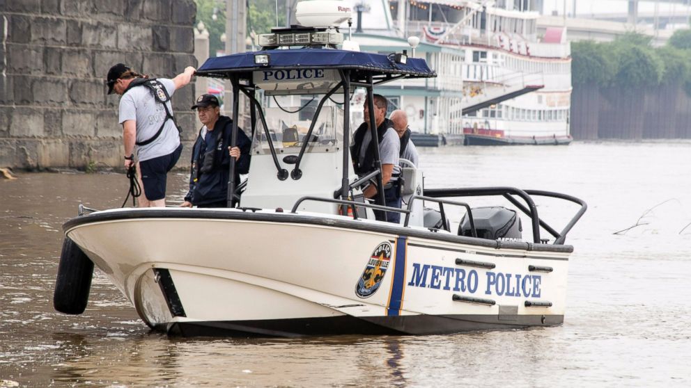 Authorities stand on a Louisville Metro Police Department boat,  July 5, 2015, on the Ohio River in Louisville, Ky. 