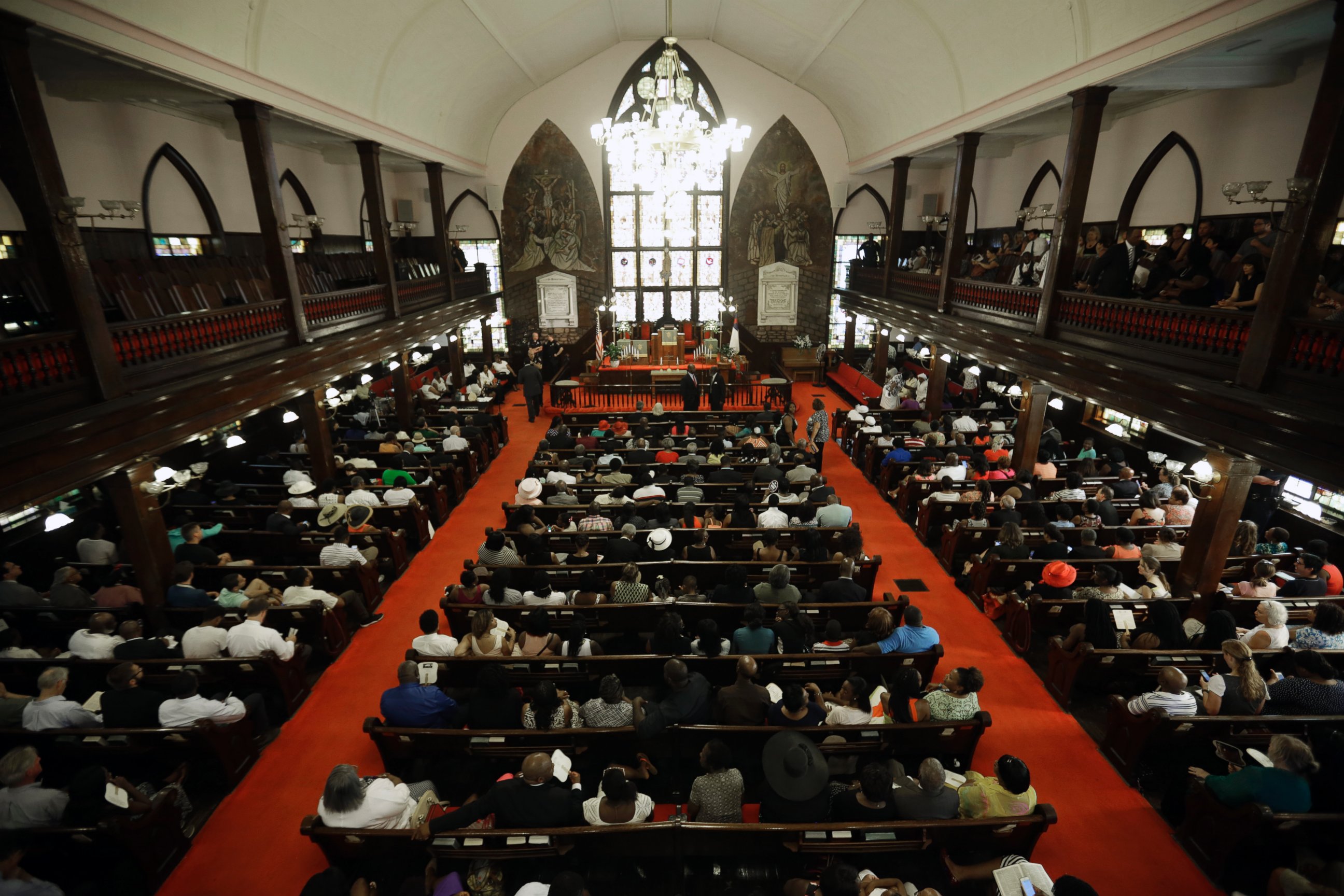 PHOTO: Parishioners sit at the Emanuel A.M.E. Church four days after a mass shooting that claimed the lives of it's pastor and eight others, June 21, 2015, in Charleston, S.C. 