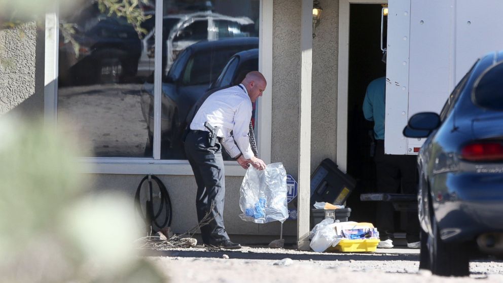 Tucson Police Department investigators and evidence technicians investigate the scene at a home where two people were arrested, Nov. 26, 2013, after three girls told authorities that they have been imprisoned for possibly the past two years, in Tucson, Ariz. 