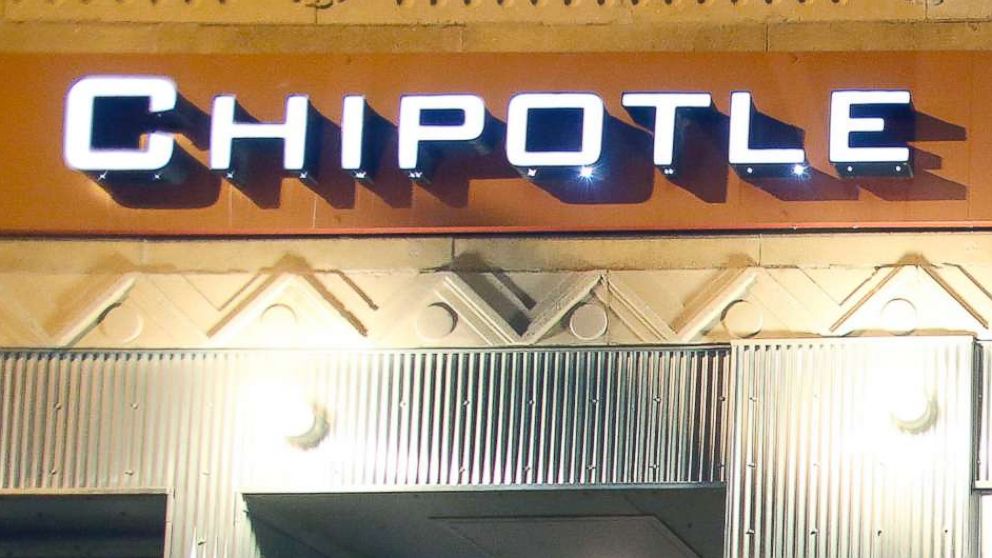 PHOTO: A man walks near a closed Chipotle restaurant, Dec. 7, 2015, in the Cleveland Circle neighborhood of Boston.