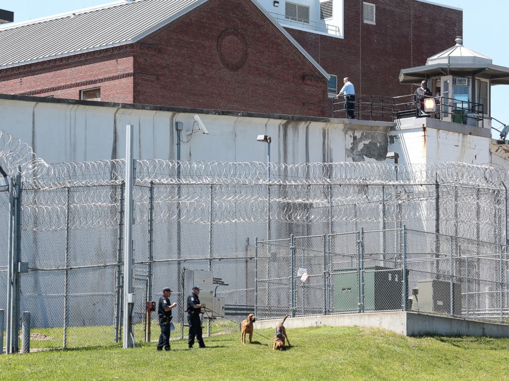 PHOTO: Law enforcement officers with bloodhounds stand guard at one of the entrances to the Clinton Correctional Facility in Dannemora, N.Y. on Saturday, June 6, 2015.