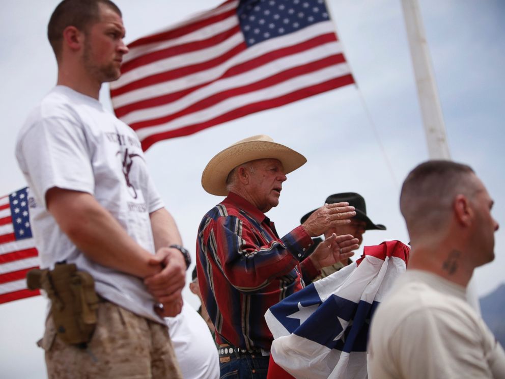PHOTO: Flanked by armed supporters, rancher Cliven Bundy speaks at a protest camp near Bunkerville, Nev. Friday, April 18, 2014.