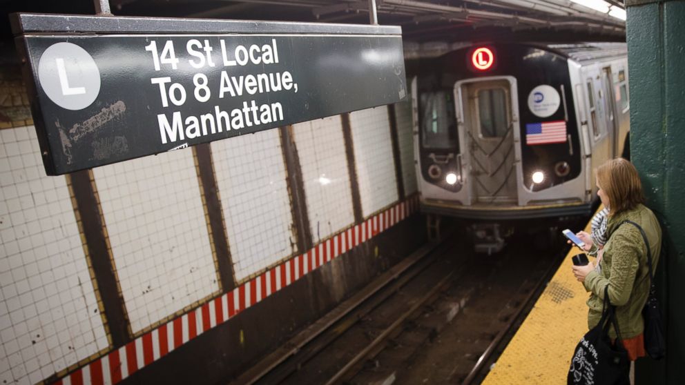 A rider waits for the L train, Oct. 24, 2014, in New York. 