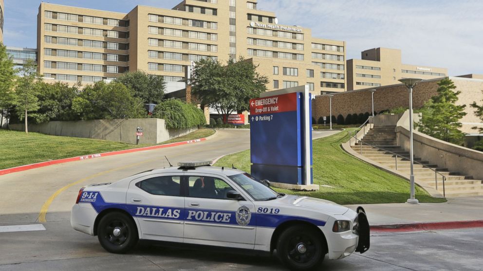 A police car drives past the entrance to the Texas Health Presbyterian Hospital in Dallas, Sept. 30, 2014.  