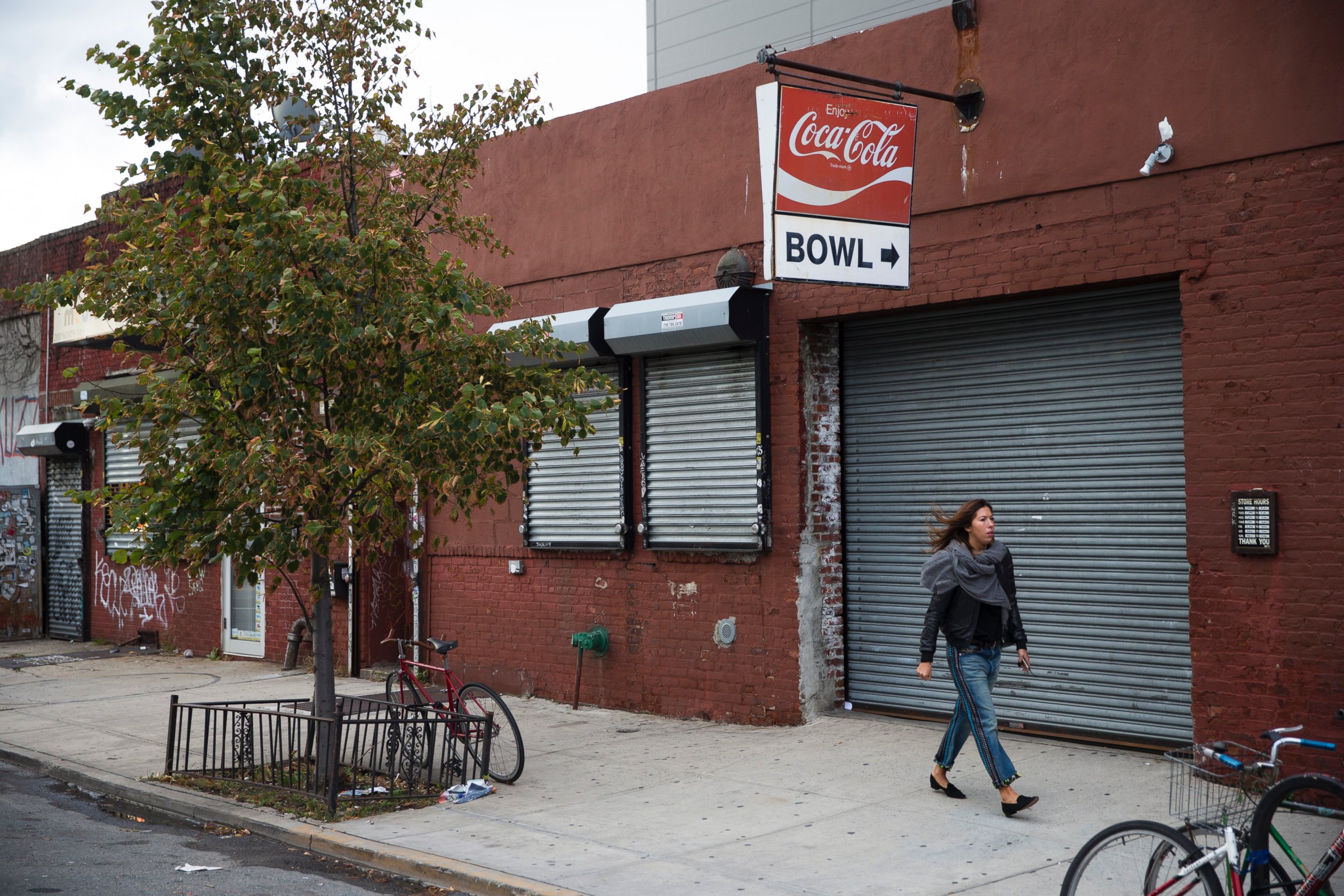 PHOTO: A pedestrian walks past The Gutter bowling alley in the Williamsburg neighborhood of New York on Friday, Oct. 24, 2014.