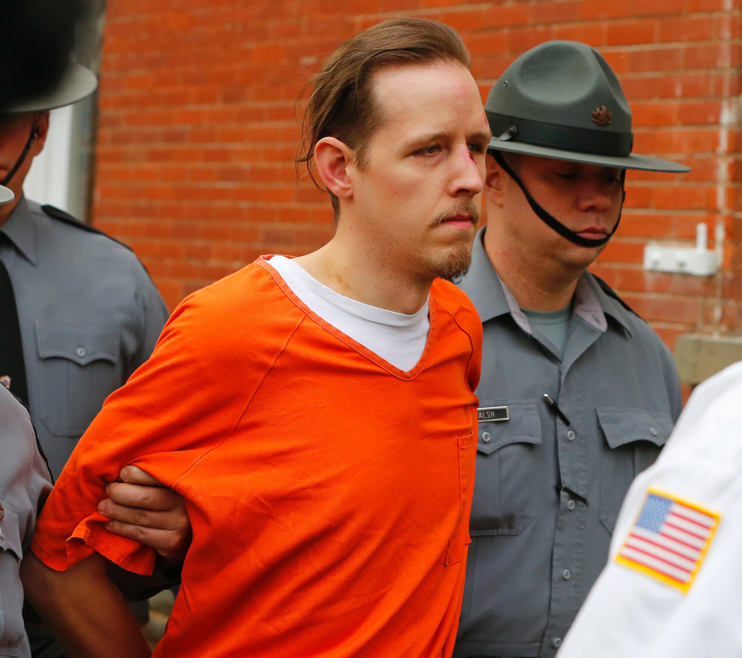 PHOTO: Eric Frein is escorted by police out the Pike County Courthouse after his arraignment in Milford, Pa., Oct. 31, 2014.