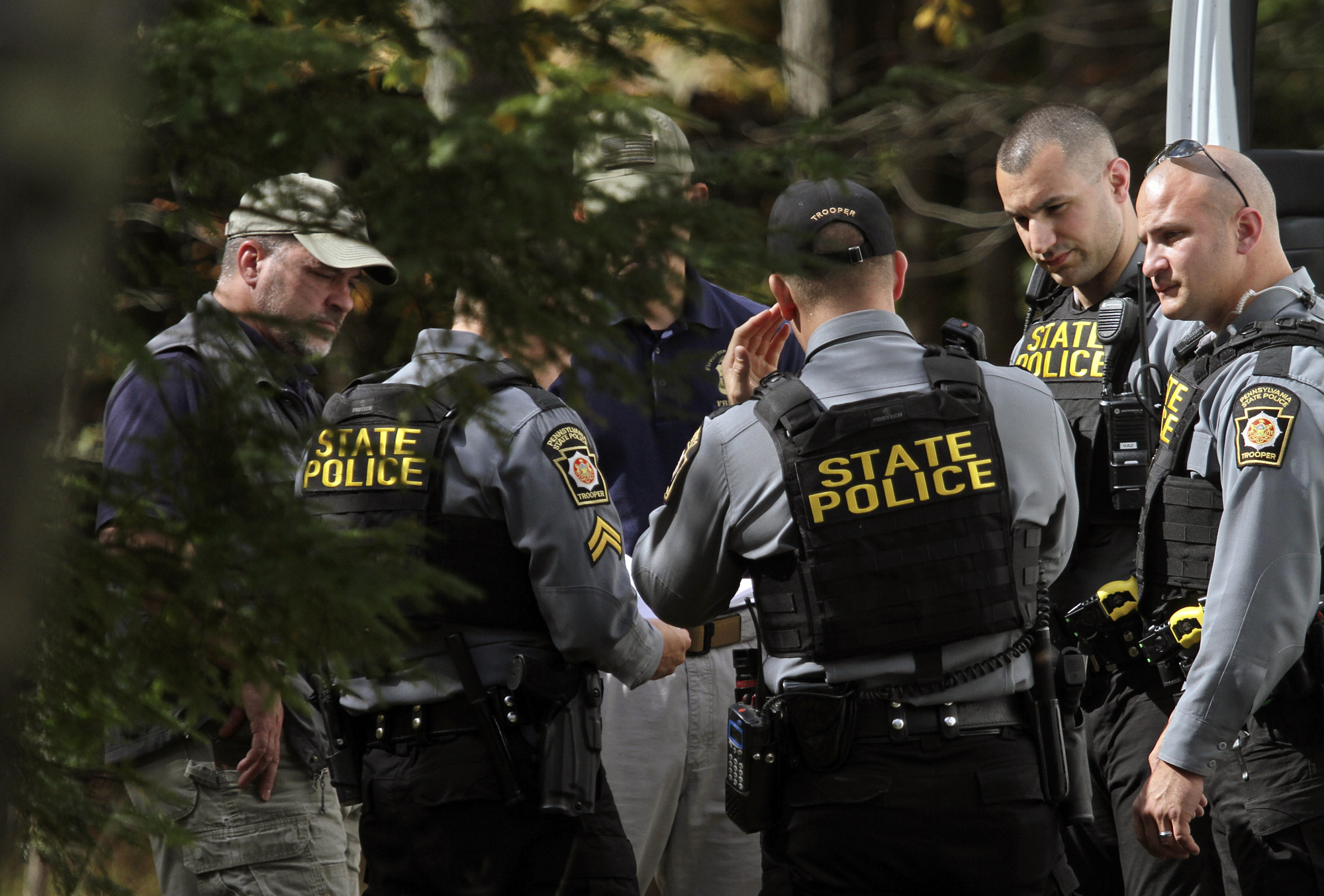 PHOTO: Pennsylvania State Police conferred along Snow Hill Road in Price Township, Pennsylvania, Sept. 30, 2014, as the search for suspected killer Eric Frein carried on for the 18th day.