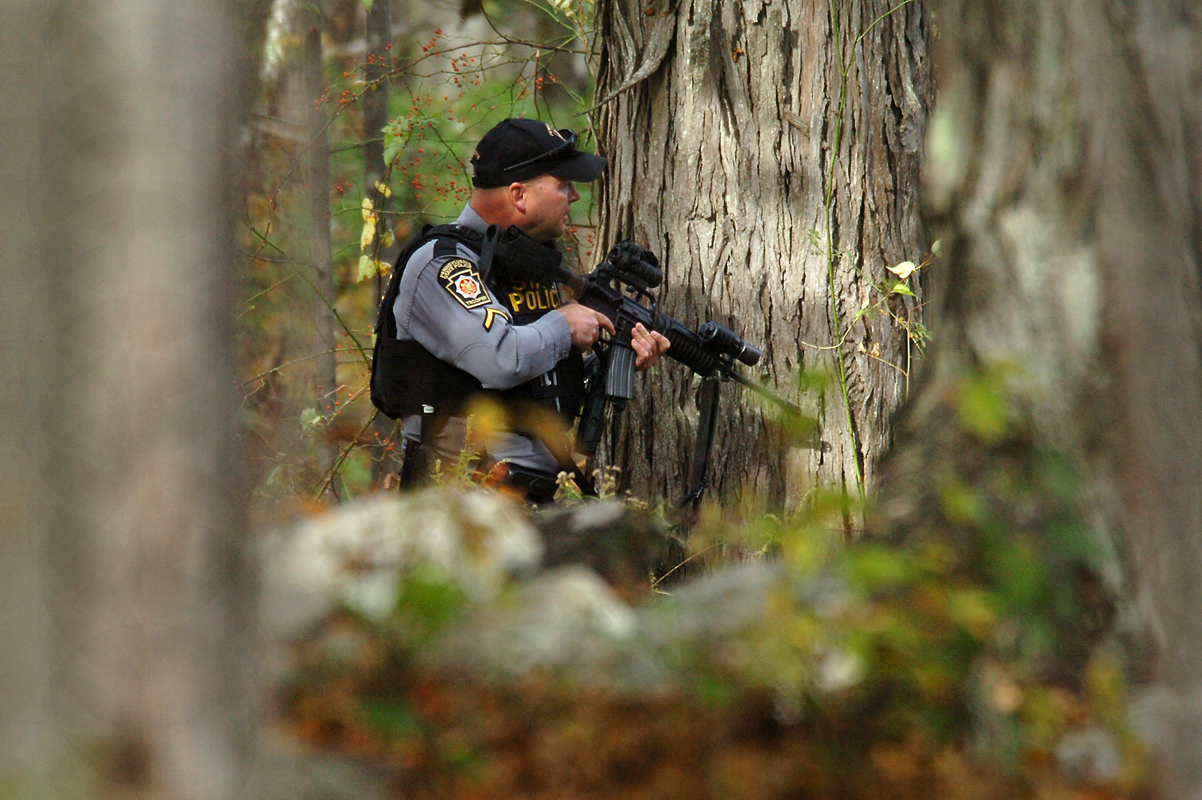 PHOTO: A Pennsylvania State Trooper searches the woods near Lower Swiftwater Road in Swiftwater, Pa., Oct. 18, 2014 during a massive manhunt for killer Eric Frein.