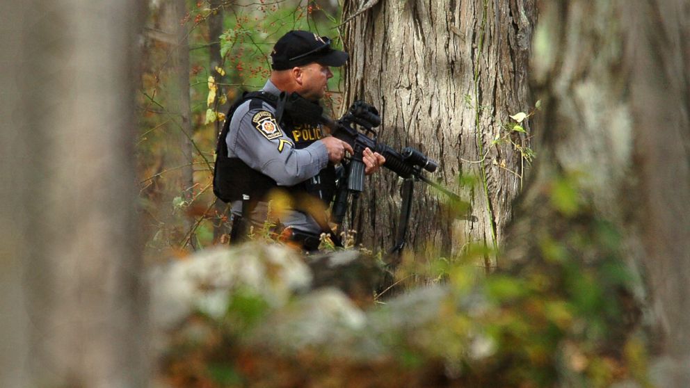 PHOTO: A Pennsylvania State Trooper searches the woods near Lower Swiftwater Road in Swiftwater, Pa., Oct. 18, 2014 during a massive manhunt for killer Eric Frein.