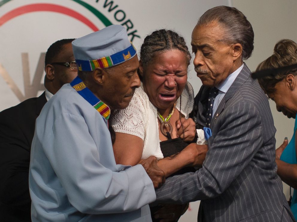 PHOTO: Esaw Garner, wife of Eric Garner, breaks down in the arms of Rev. Herbert Daughtry, center, and Rev. Al Sharpton, right, during a rally at the National Action Network headquarters for Eric Garner, Saturday, July 19, 2014, in New York.