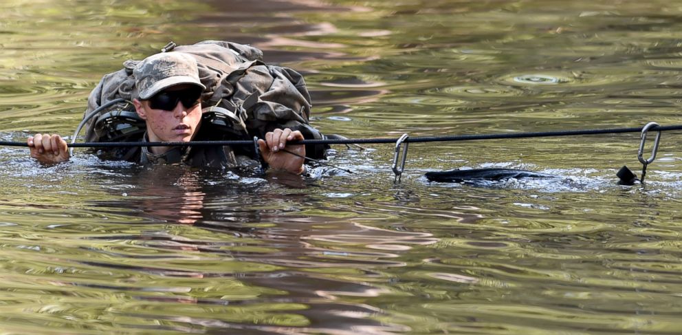 PHOTO: A female Army Ranger crosses the Yellow River on a rope bridge during Ranger School at Camp Rudder on Eglin Air Force Base, in Fla.