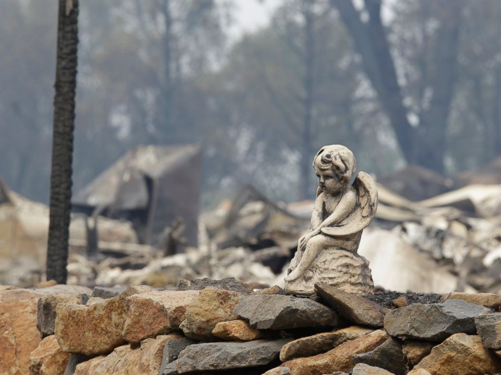 PHOTO: The figure sits on a rock wall outside a hillside home destroyed by fire, Sept. 13, 2015, in Hidden Valley, Calif.