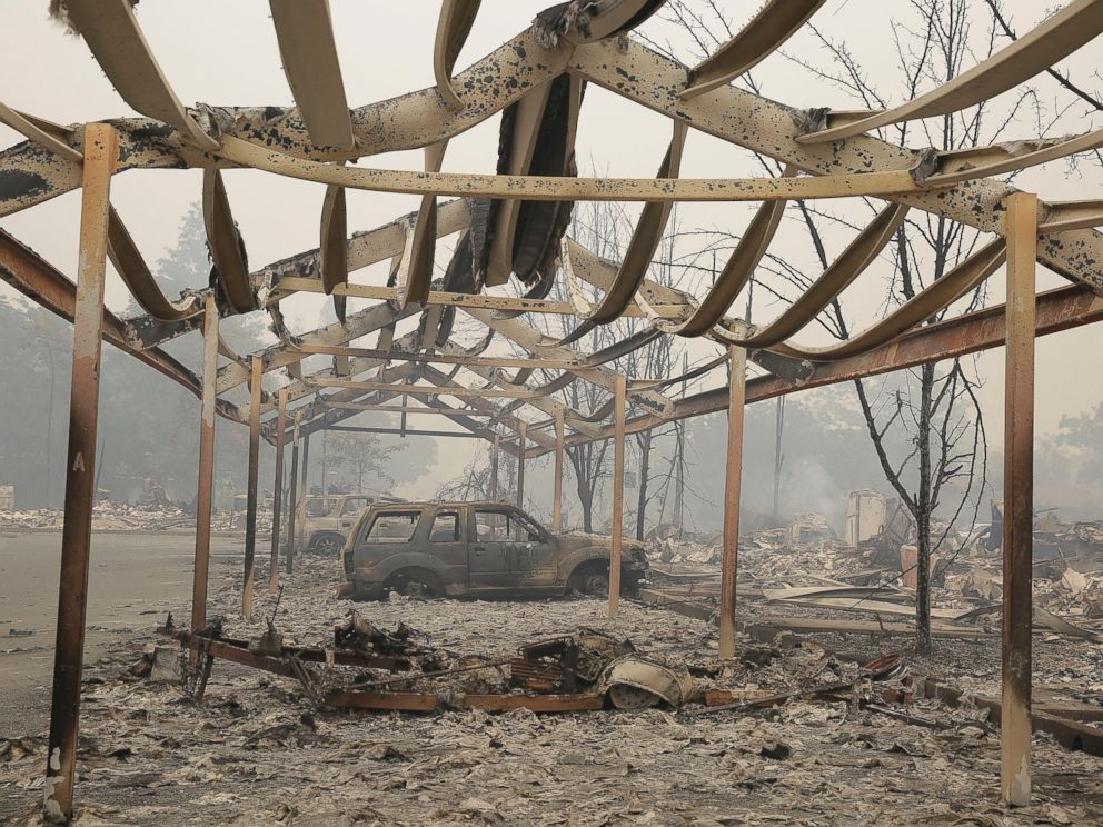 PHOTO:A carport frame and burned cars remain outside an apartment complex destroyed by fire, Sept. 13, 2015, in Middletown, Calif.