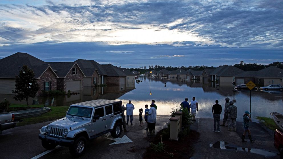 PHOTO: Residents line up on Providence Boulevard in Hammond, La., where flood waters inundated their homes after heavy rains in the region Saturday, Aug. 13, 2016.