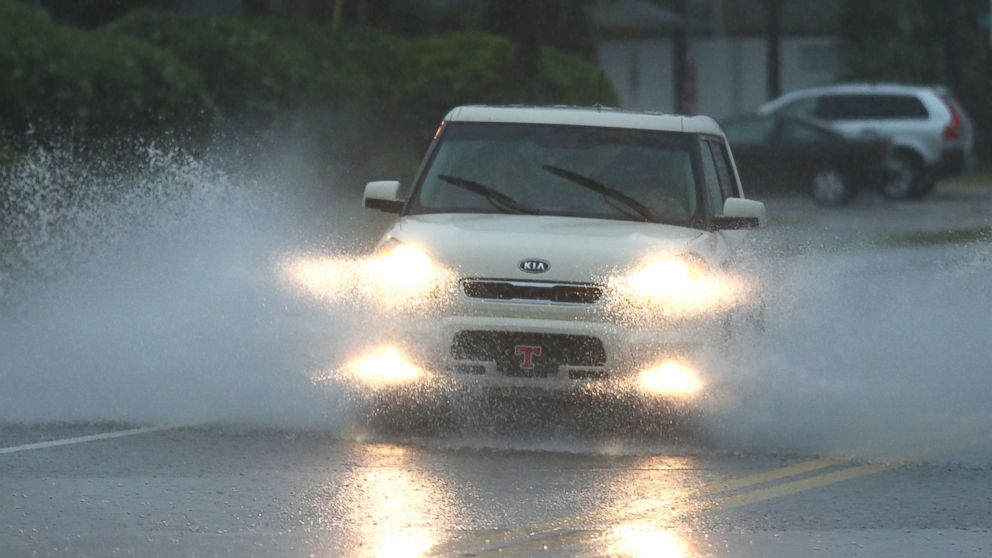 A vehicle drives through heavy flooding on Thomas Drive during rush hour in Panama City, Fla., April 29, 2014. 