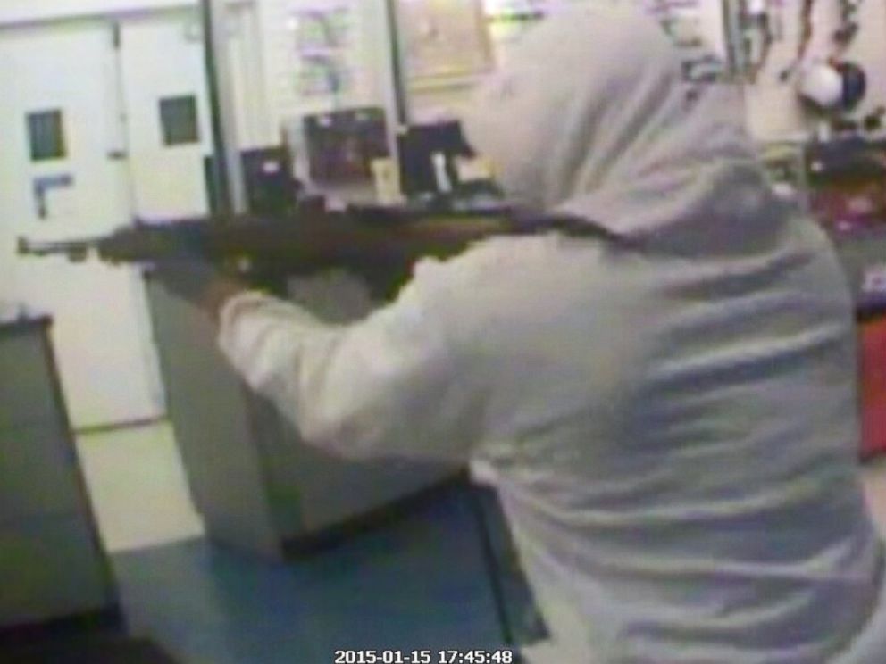 PHOTO: A suspect aims a rifle as he robs a pawn shop, Jan, 15, 2015, in Haines City, Fla., in this security camera video grab. 