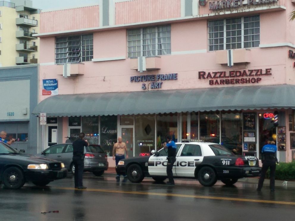 PHOTO: In this photo provided by Marcellus Johnson, authorities draw their guns on a man suspected in a bank robbery, Dec. 5, 2015, in Miami Beach, Fla.