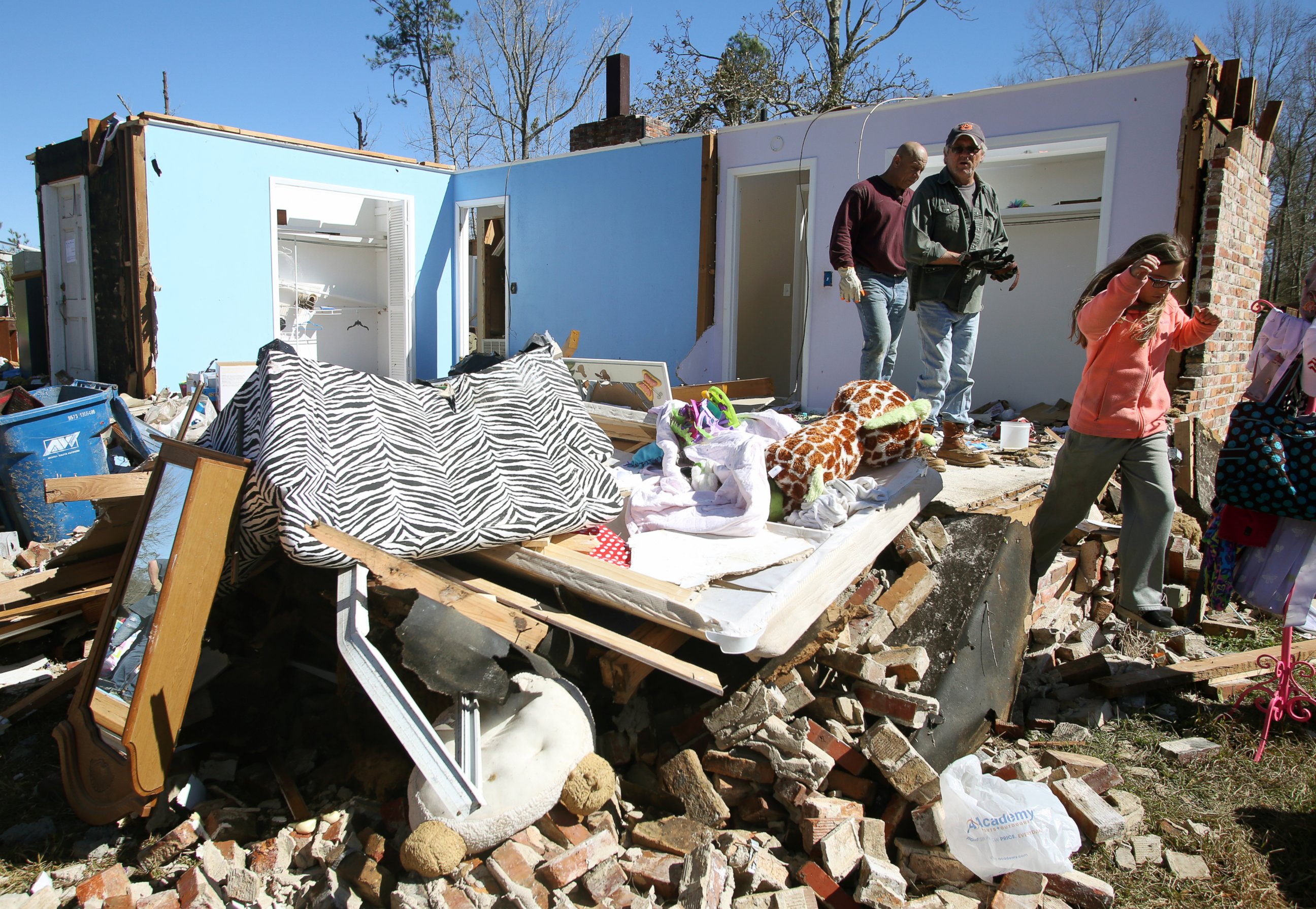 PHOTO: Residents and neighbors salvage items from the debris of a home that was damaged by severe weather that struck the prior evening in Century, Fla., Feb. 16, 2016.