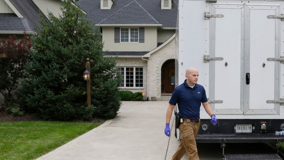 Federal authorities walk outside of the home of Subway restaurant spokesman Jared Fogle, July 7, 2015, in Zionsville, Ind.