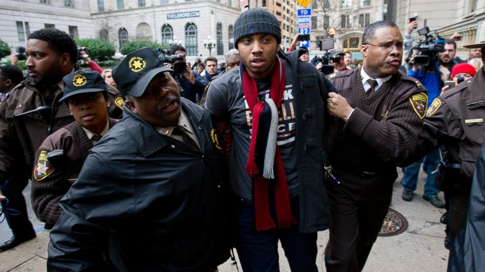 A demonstrator is detained outside of the courthouse after a mistrial of Officer William Porter, one of six Baltimore city police officers charged in connection to the death of Freddie Gray, Dec. 16, 2015, in Baltimore. 