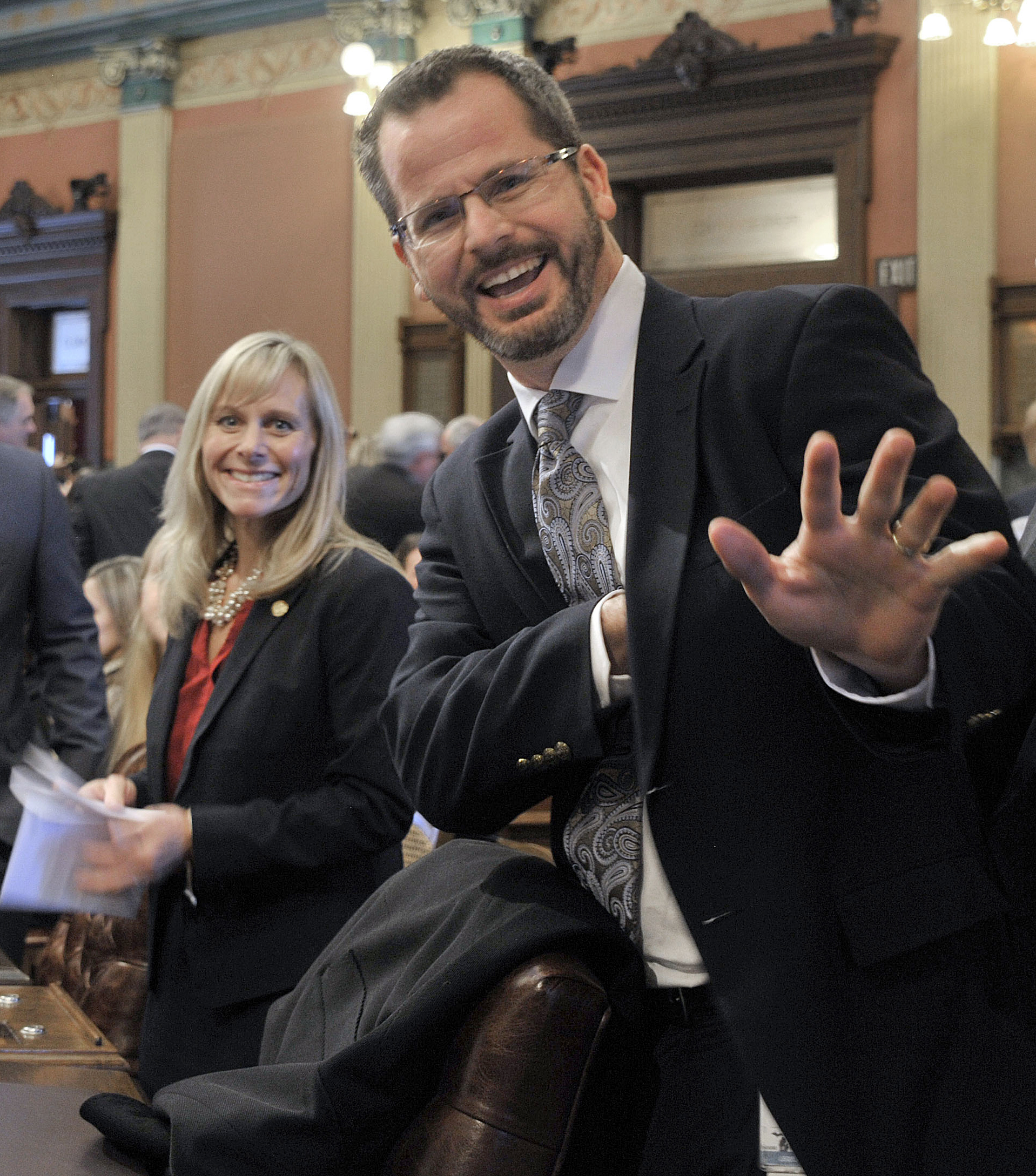 PHOTO: Rep. Cindy Gamrat and Rep Todd Courser, right, wave to reporters in the House of Representatives in Lansing, MI, Jan. 14, 2015.