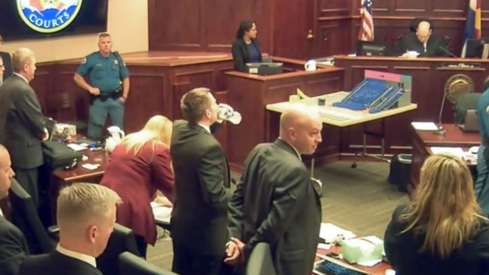 In this image made from a video, the courtroom stands as the jury is excused following Gargi Datta's testimony in a trial for Colorado theater shooter James Holmes, June 10, 2015, in Centennial, Colo.
