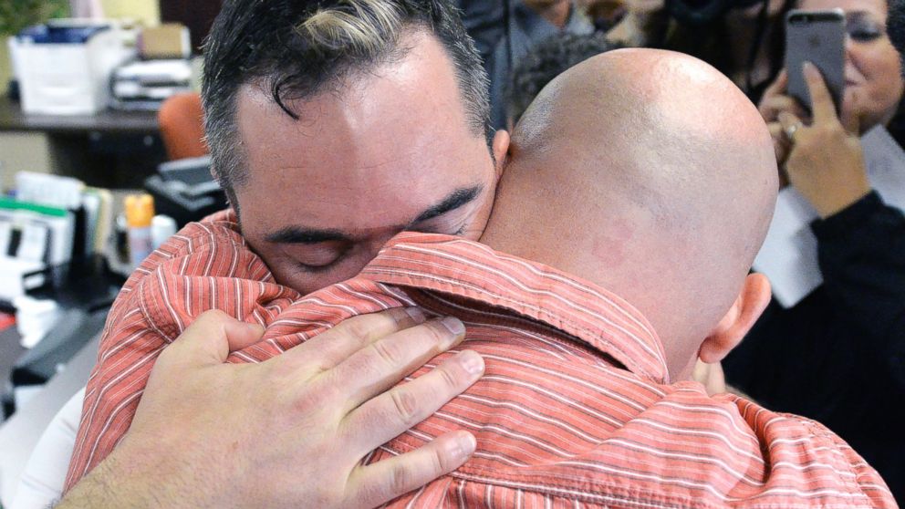 PHOTO: James Yates, left, hugs his partner William Smith Jr., after receiving their marriage license at the Rowan County Judicial Center in Morehead, Ky., Sept. 4, 2015.