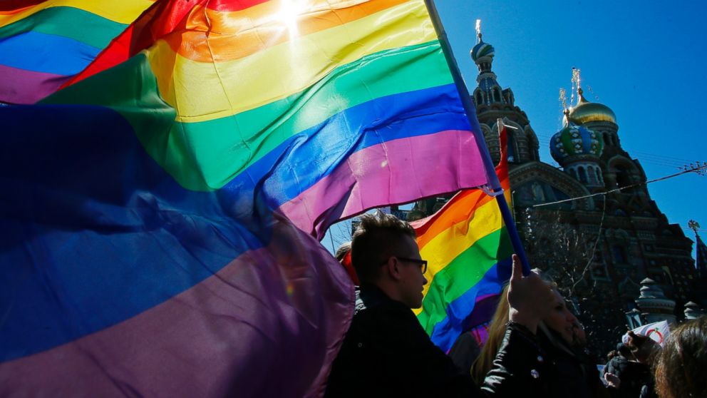 PHOTO: Gay rights activists carry rainbow flags as they march during a May Day rally in St. Petersburg, Russia on Wednesday, May 1, 2013.