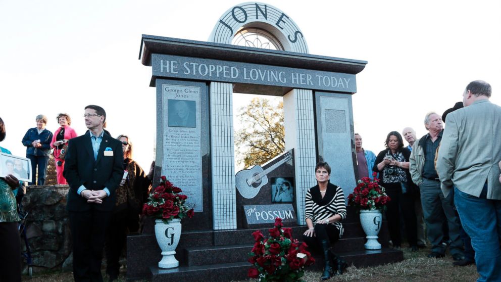 Nancy Jones, widow of country music star George Jones, listens as the Jones Boys band plays as she sits at the memorial unveiled at the late singer's grave Nov. 18, 2013, in Nashville, Tenn.