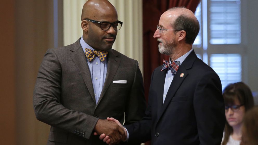 State Senators Isadore Hall III, left, and Steven Glazer shake hands after their "bullet button" bill was approved by the Senate, May 19, 2016, in Sacramento, Calif. 