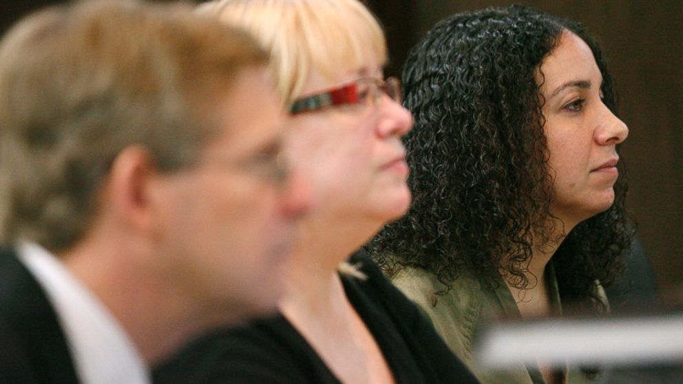 Hannah Overton, far right, sits next to her attorney, Cynthia Orr, center, and prosecutor, Doug Norman, April 26, 2012 in Corpus Christi, Texas.