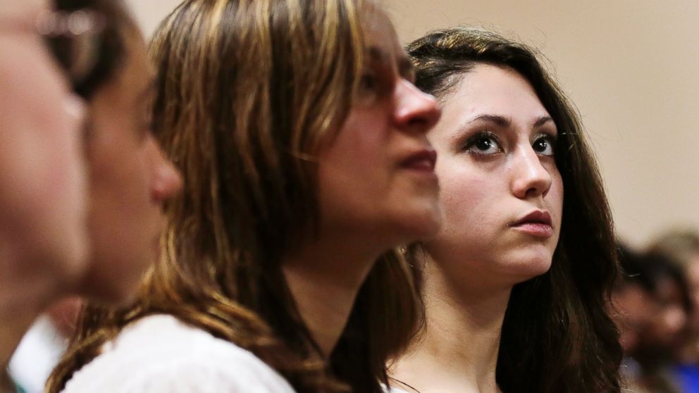 Abigail Hernandez, right, sits with family and friends as she listens to her mother Zenya Hernandez, center, talk with N.H. Senior Assistant Attorney General Jane Young, right, prior to the arraignment of Nathaniel Kibby, 34, of Gorham, N.H. at Conway District Court in Conway, N.H., July 29, 2014.